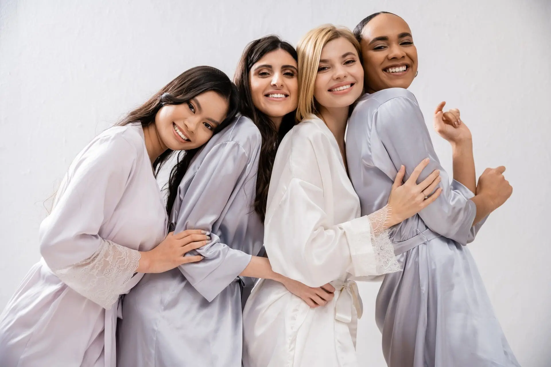 bridal-shower-four-women-happy-bride-and-bridesmaids-in-silk-robes-looking-at-camera-cultural.jpg